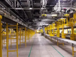 A warehouse with yellow pipes and metal equipment.